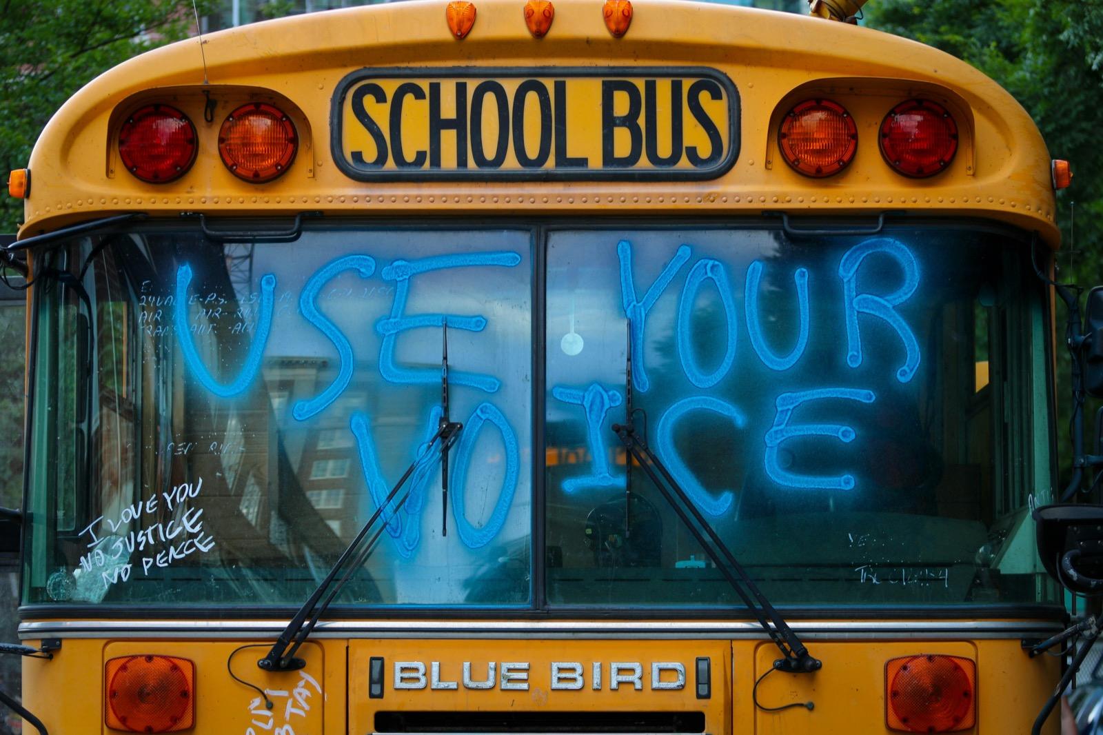 Yellow school bus with green and yellow lights